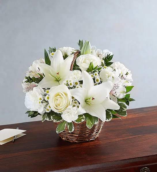 Peace, Prayers, &amp; Blessings- All White - Product ID: 95383   Make a heartfelt gesture of your sympathy with our classic all-white basket arrangement of roses, lilies, alstroemeria, carnations and monte casino. Hand-gathered into a lovely willow handled basket, itâs a simple yet touching way to offer peace and comfort during their time of sorrow. Hand-gathered basket arrangement of white roses, lilies, alstroemeria, carnations, mini carnations, and monte casino, accented with variegated pittosporum Designed in a willow handled basket; measures 8"H Appropriate to send to the home of friends and family members or to the memorial service Large arrangement measures approximately 12"H x 12"L Medium arrangement measures approximately 11"H x 11"L Small arrangement measures approximately 10"H X 10"L Our florists hand-design each arrangement, so colors, varieties, and basket may vary due to local availability