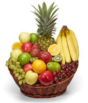 Basket of assorted fruit including bananas, pineapple, grapes, apples, and citrus