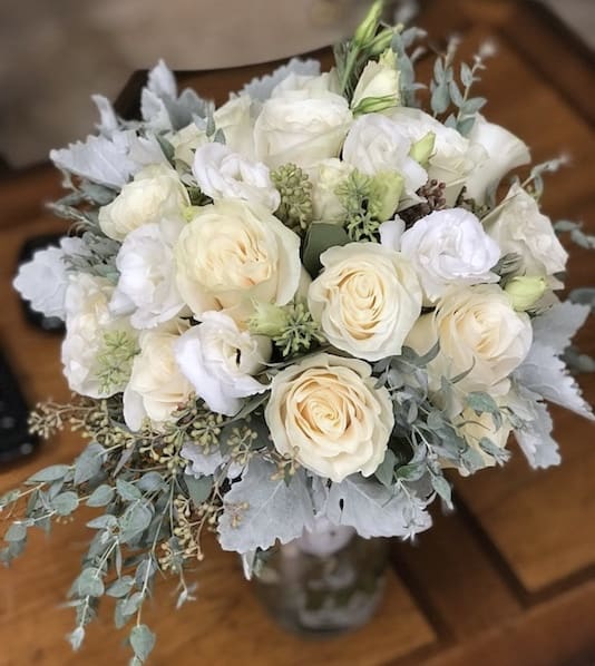 Bouquet of white roses and pale blooms with silvery foliage