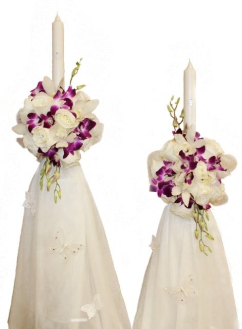 Two white floral candle arrangements with purple orchids