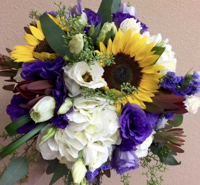 Bouquet of sunflowers, white blooms, and purple flowers