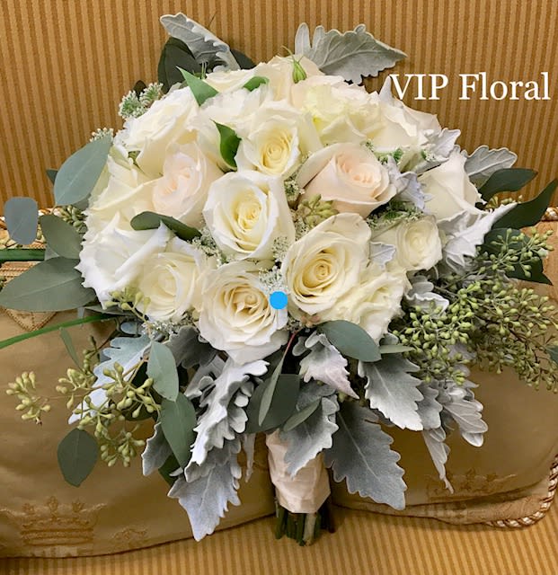 White rose bouquet with silver foliage and green accents