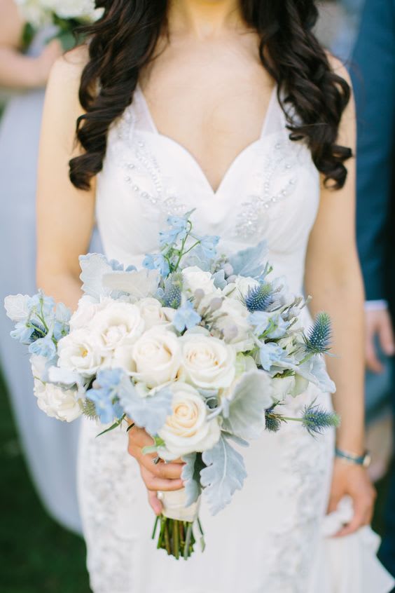 Bride holding a white and pale blue bouquet