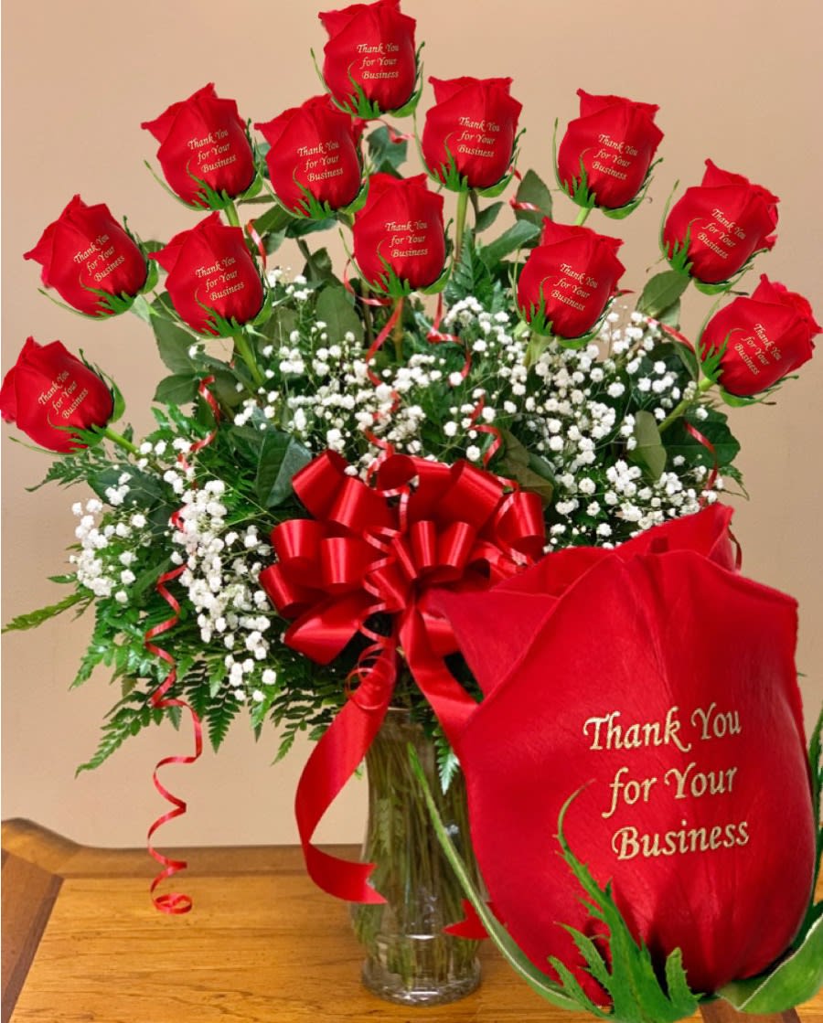Bouquet of red roses with a red ribbon in a glass vase