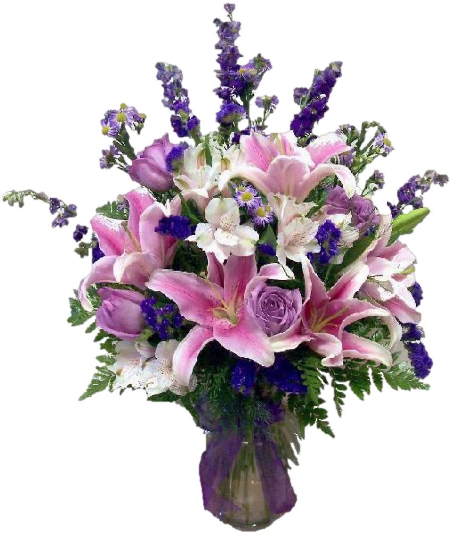 Bouquet of pink lilies, purple roses, and white flowers in a vase