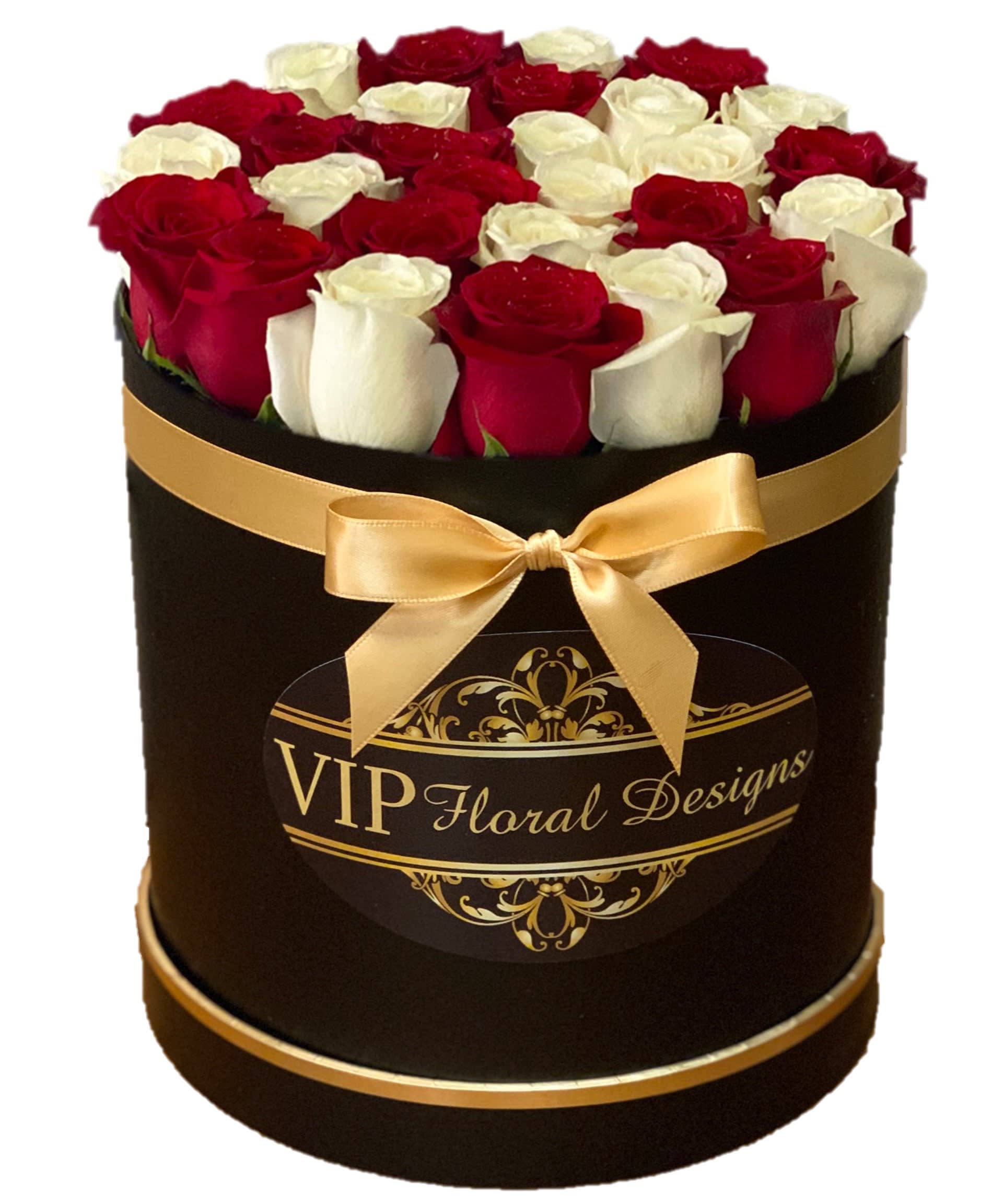 Red and white roses arranged in a black hat box with a gold ribbon