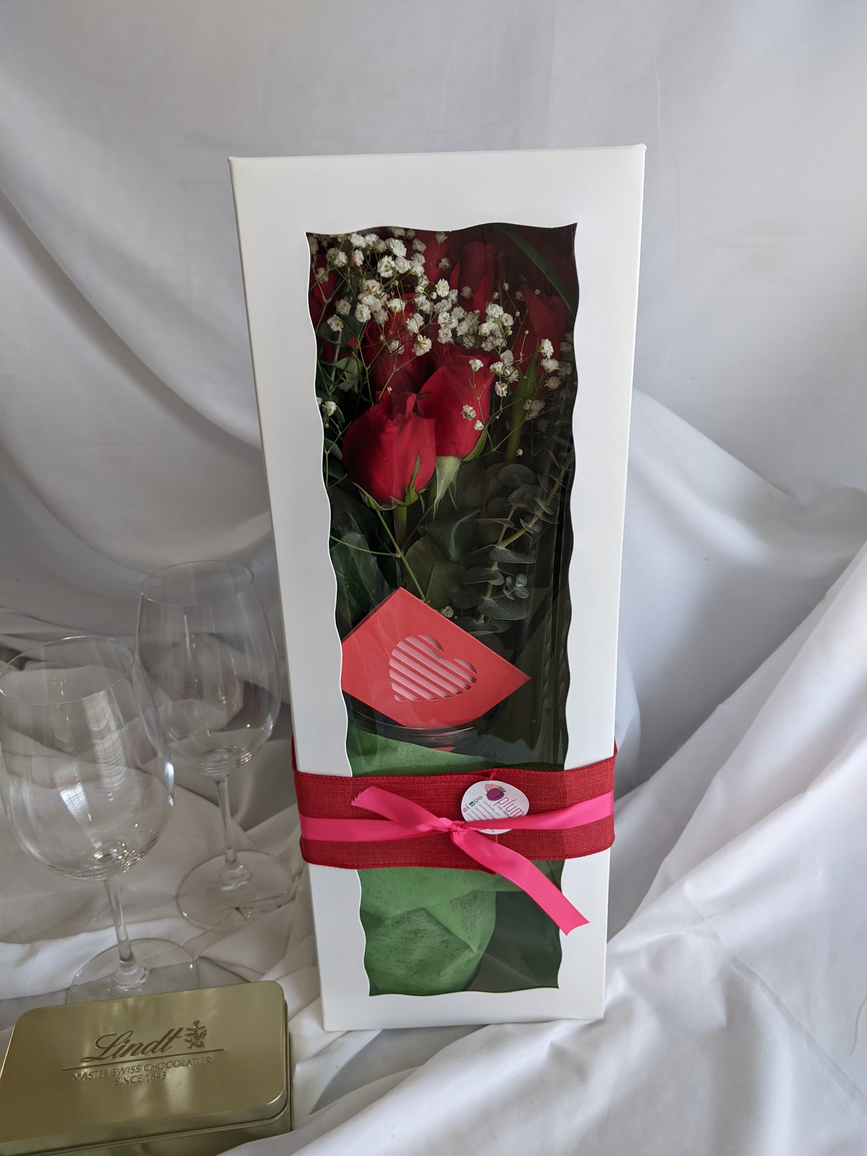 Boxed bouquet of red roses with white baby's breath