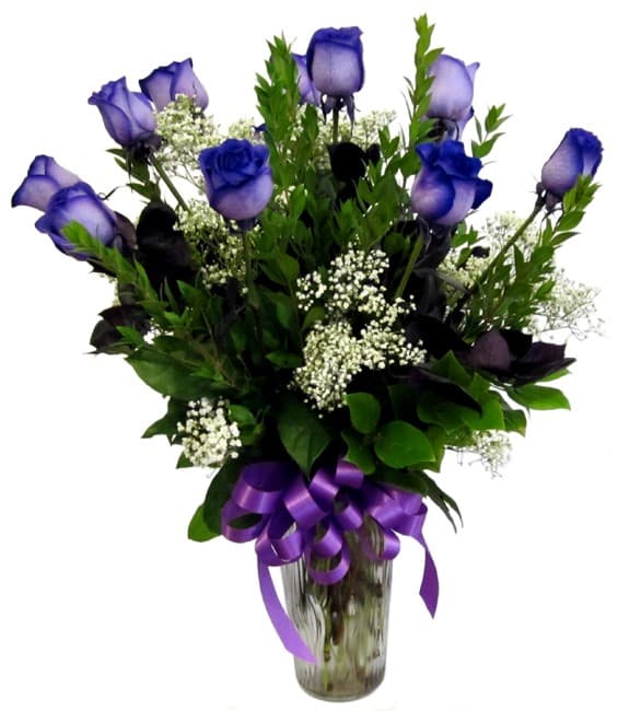 Purple roses in a glass vase with a purple ribbon