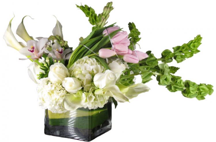 White and pink flowers arranged in a square glass vase