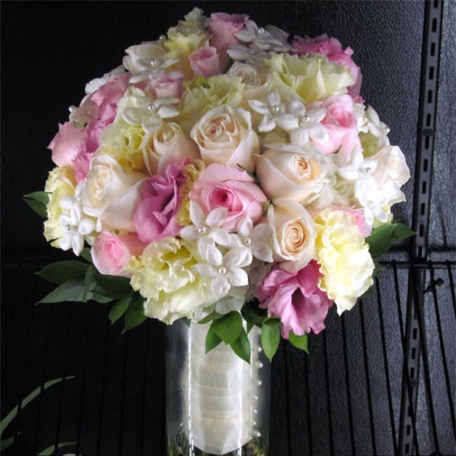 Pink and cream rose bouquet in a clear vase