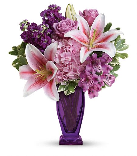 Pink lilies and roses in a purple vase