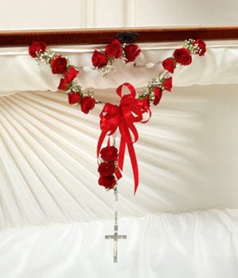 Small Rosary with spray roses - Express your faith and love with this inspiring and beautiful floral tribute. The small SprayRose Rosary for sympathy is created by one of our local florist partners Spray roses are strung in a row to look like a rosary with a decorative Cross. The spray roses are accented with white Baby's Breath and completed with a satin ribbon. 