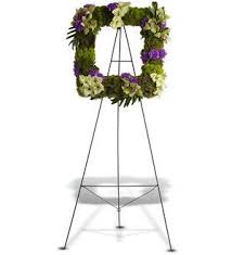 Heavenly Hope - Hope springs eternal, and this modern, moss-and-blossom "picture frame" wreath, with its soothing, natural shades of green and purple, will express your heartfelt thoughts and condolences. An appropriate tribute for a man or woman.  A standing wreath created from a mix of fresh flowers such as Cymbidium orchids, gladioli, carnations and button spray chrysanthemums – accented with leaves, moss and greenery – is delivered on an easel.   Approximately 19" (W) x 19" (H) (Dimensions do not include easel.)