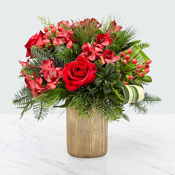 Take Me Home Bouquet - Our Take Me Home Bouquet is a stunning array of red hues and luscious greens in a gold bark ceramic vase. Comprised of red roses, red alstroemeria, red hypericum berries, aspidistra leaves, and Christmas greens, this arrangement sends a joyous, holiday greeting upon arrival. 