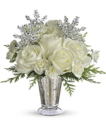 White roses and small white flowers in a silver vase