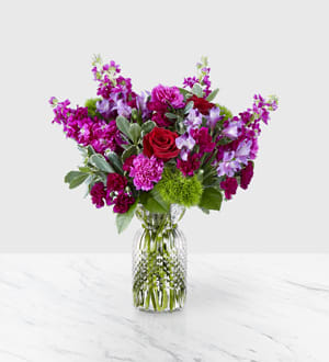 Falling For You - Brighten up your Valentine’s Day with a bouquet that has a message of love bursting from the vase. Comprised of an array of red roses, green trick Falling for You Bouquet is full of romantic blooms that will captivate your special someone.   This arrangement is artfully complete with violet mini carnations, fuchsia standard carnations, variegated pittosporum, and luscious salal, making it a bouquet that shines with effortless beauty!
