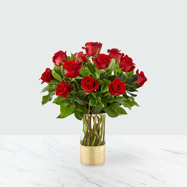 Gorgeous Rose Bouquet  - An elegant collection of deep red roses is perfect for saying, "our love is timeless," or "you are my favorite part of everyday". Set in a clear glass vase with a metallic gold, hammered honeycomb base and accented by luscious pittosporum and salal, our florists have created an arrangement of romantic roses that is a classic beauty for your darling. 