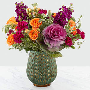 Autumn Harvest  - Celebrate the season with a fresh take on traditional harvest arrangements. Comprised of purple ornamental kale, orange roses, orange spray roses, purple stock and peach hypericum berries, our Autumn Harvest Bouquet is a simply stunning arrangement. With gorgeous blooms completed by a sophisticated, statement vase, this bouquet is perfect for celebrating the season your way with its unique style.