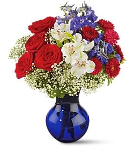 Red, White and True  - Stay true to the red; white and blue… send this grand bouquet of roses; delphinium and more; and your patriotic spirit will shine through! The lovely cobalt blue vase will be enjoyed all year round.
