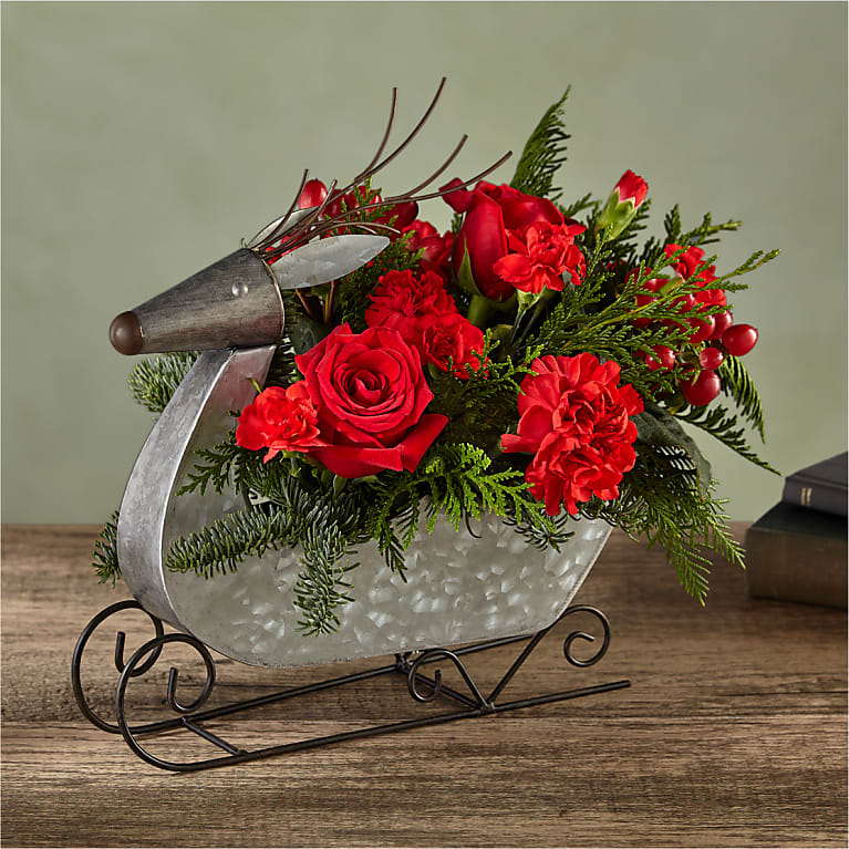 Prancer  Bouquet - Fly into Christmas Eve with this dashing Prancer Bouquet designed in a reindeer sleigh filled with red blooms, hypericum berries, and evergreen accents.