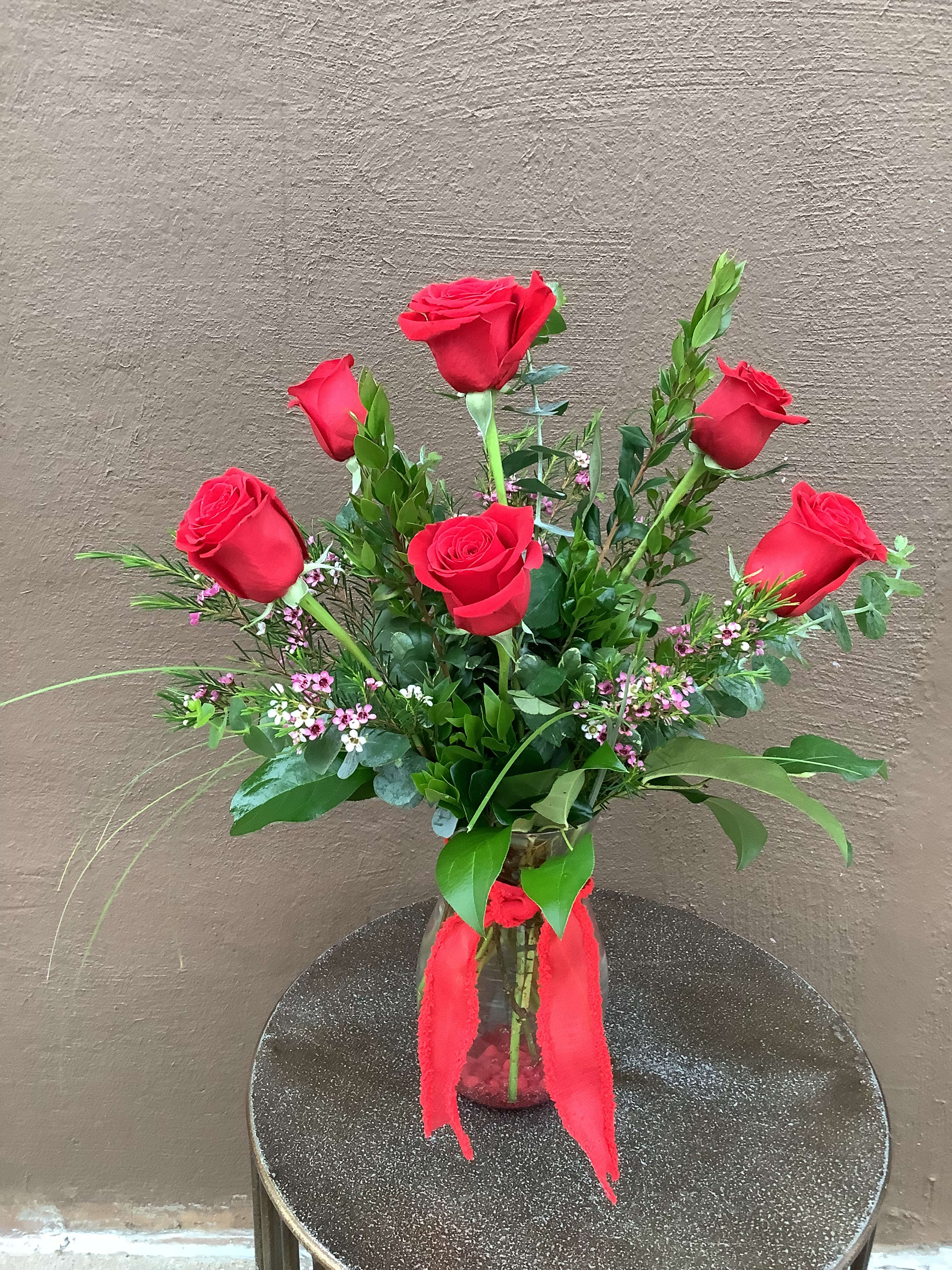 6 long stem red roses - Six long stem red roses with beautiful foliage and accent flowers in a clear glass vase. 