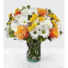 Sweet Moments Bouquet - Through a collection of bold hues, gorgeous flowers, and fresh scents, this bouquet blossoms with beauty in any room that its placed. An array of orange roses, variegated pittosporum, and white daisy pompons come together in a cylindrical glass vase to make the perfect gift for a loved one near or far. 