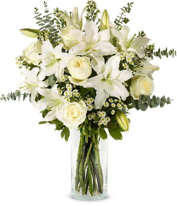 Alluring Whites - Assortment of White flowers like lilies, roses, monte casino aster &amp; eucalyptus to accent. 