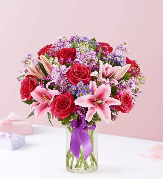 Straight From The Heart Bouquet - A gift means so much more when it’s straight from the heart. Our stunning Valentine’s bouquet of passionate pinks and purples is expertly arranged in our chic cylinder vase and wrapped in a purple satin ribbon for the perfect finishing touch. It’s a romantic surprise that speaks volumes about the love you feel.