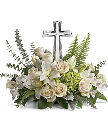 Teleflora's Divine Peace Bouquet - An elegant display of faith and divine peace, this beautiful arrangement will comfort the bereaved in a truly thoughtful and respectful way. An exquisite crystal cross "keepsake" ($25 value) is surrounded by a bed of lovely blossoms. It is sure to be appreciated and always remembered.  Approximately 14 1/2" W x 13 1/2" H  Orientation: One-Sided  As Shown : T229-2A Deluxe : T229-2B