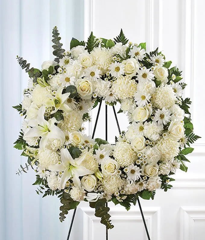 Serenity Wreath - A ring of fragrant, bright white blossoms will create a serene display at any funeral or wake. This classic wreath is delivered on an easel, and is a thoughtful expression of sympathy and admiration. 