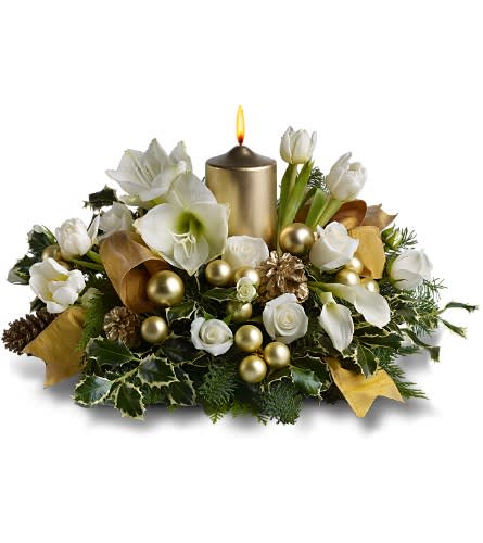Golden Illuminations  - Cast a golden illumination upon your holiday celebration with this gleaming display of pure white blossoms and fresh evergreens, mingled with decorative golden elements, and arranged around a gold-colored pillar candle - and add a touch of splendor to any special event.    A mix of fresh white flowers such as amaryllis, tulips, spray roses and miniature callas, plus fresh evergreens â accented with golden ornament balls, gold-sprayed pinecones and a golden ribbon â is arranged in a dish around a golden pillar candle.    Approximately 22" (W) x 12" (H)    Orientation: All-Around        As Shown : TFWEB476    