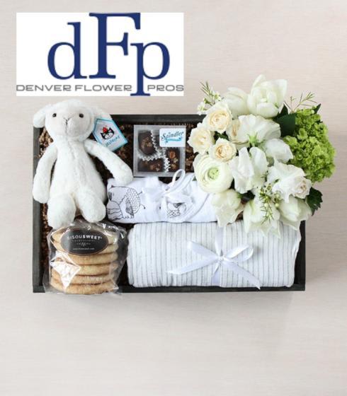 Baby Flowers and Gift crate - Boy - Denver Flower Pros presents the following deluxe  baby gift crate for the new born Bundle of Joy. A new addition to the family deserves much celebration—and our deluxe basket offers just that. Our wood crate is snugly tucked with a plush stuffed animal, as well as a baby blanket swaddle .Mom and Dad will love fresh baked cookies, a luxurious inlaid chocolate bar, a 4 pack box of chocolate truffles , a soy candle and a beautiful arrangement of flowers. The bear might be substituted for a different one to availability issues. You can select the gender