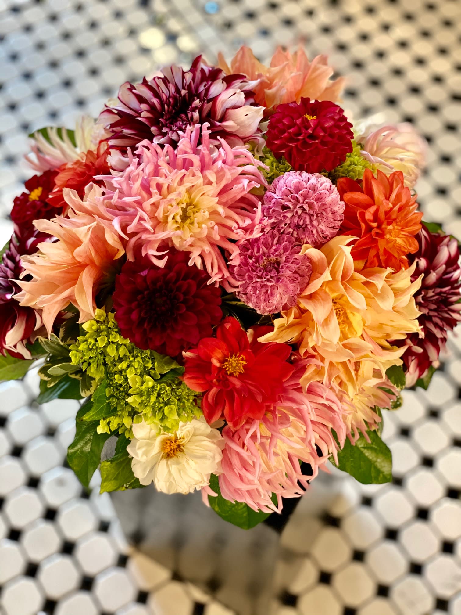 Mixed bouquet of colorful dahlias with green foliage