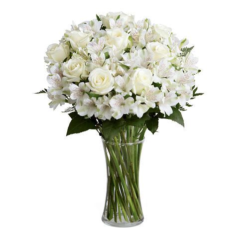 Cherished Friend  Bouquet - The  Cherished Friend Bouquet offers comfort and sympathy in the time of grief and loss. Bright white roses and Peruvian lilies are accented by lush greens and gorgeously arranged in a clear glass gathering vase to create a bouquet that will bring peace and show how much you care.
