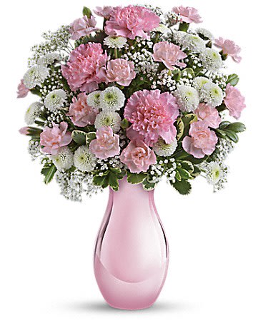 Pink and white carnation bouquet in a pink glass vase