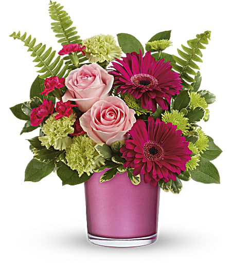 Pink roses and magenta daisies in a pink glass vase
