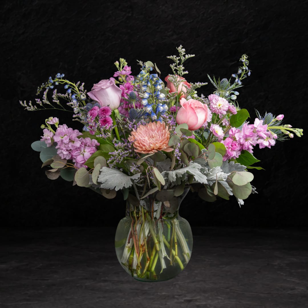 Mixed pink and lavender bouquet in a clear glass vase
