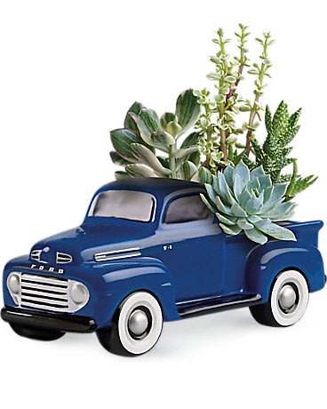 Blue vintage truck planter with succulents in the bed