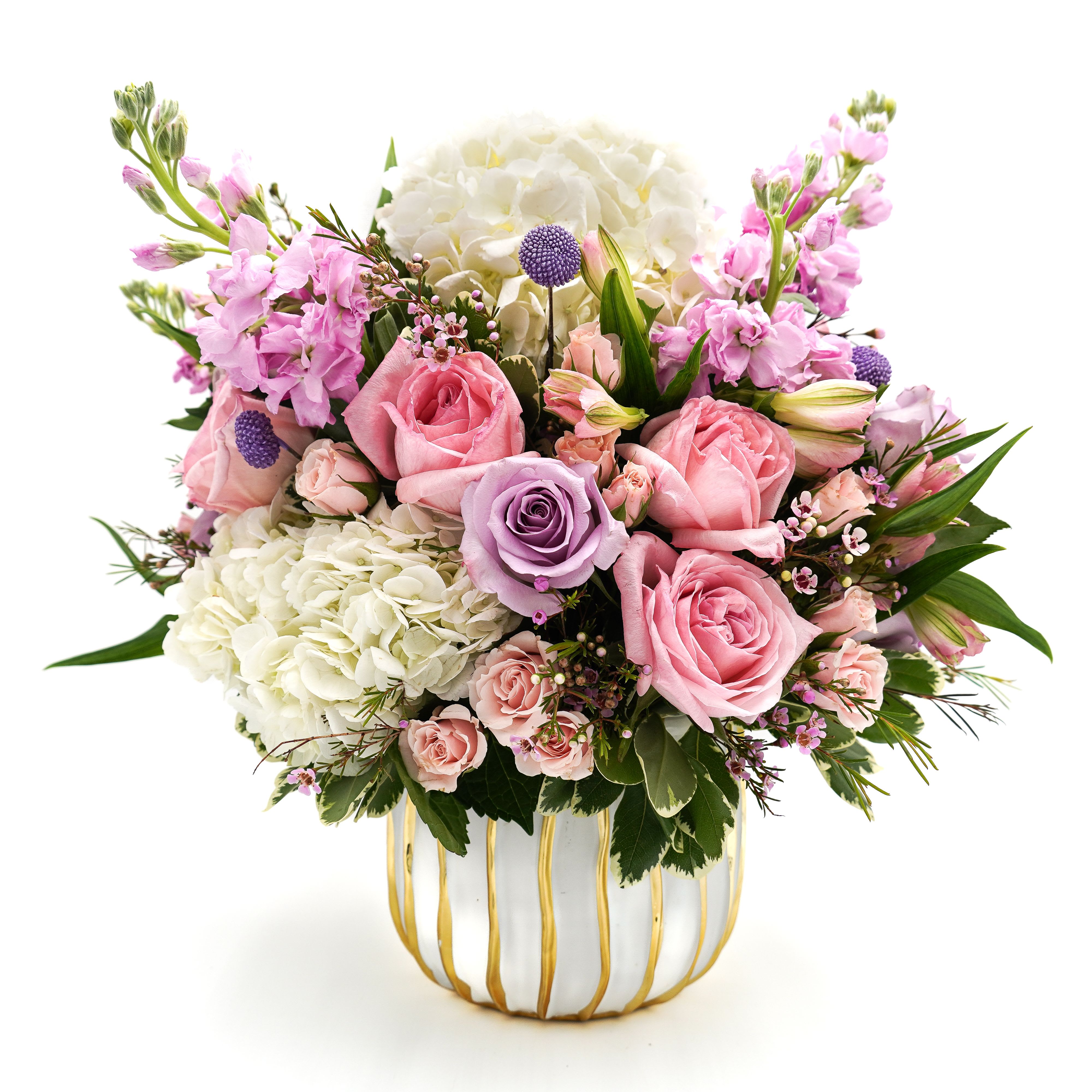 Pink and white flower arrangement in a striped ceramic vase