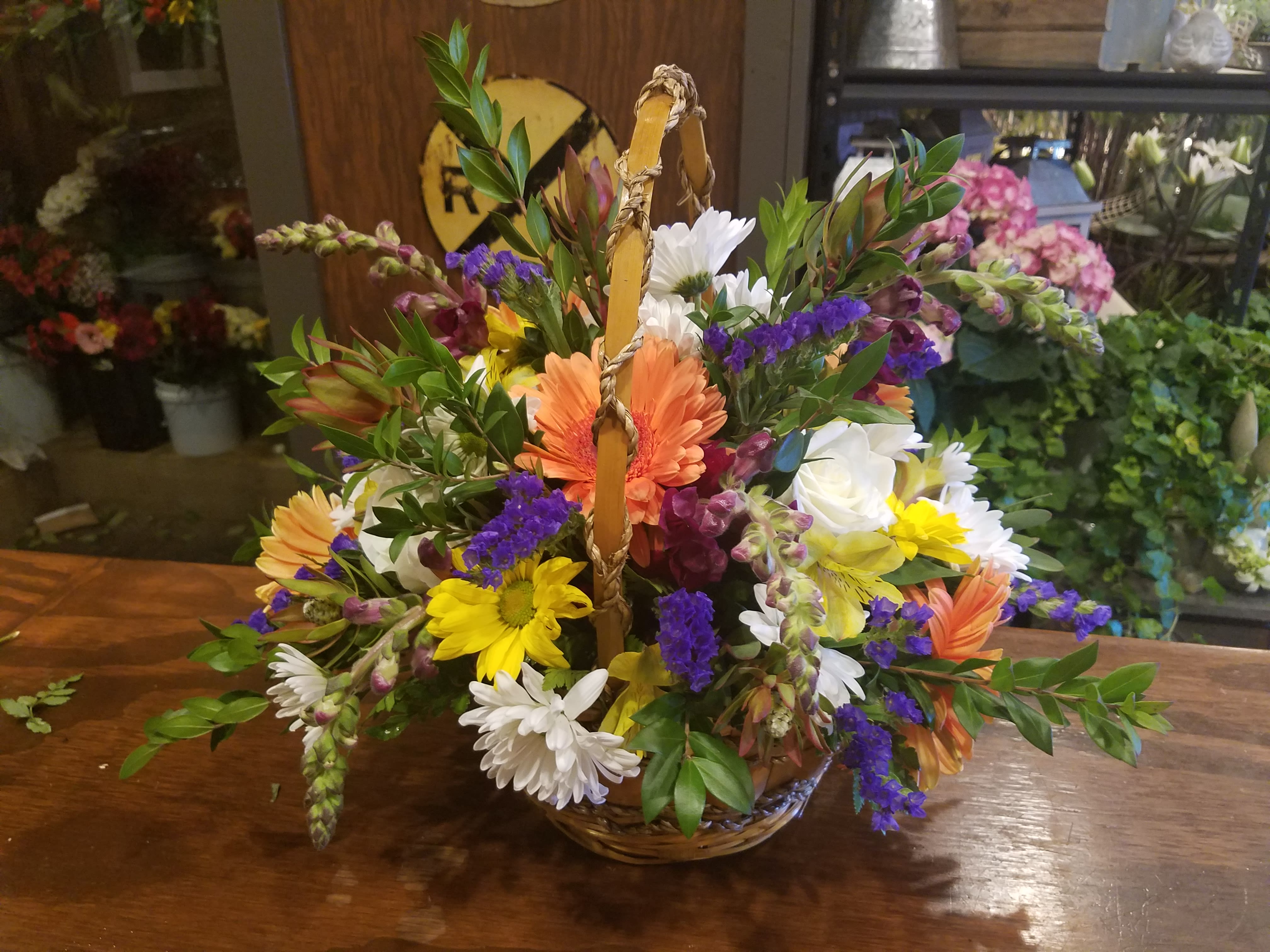 Mixed flower basket with daisies, gerbera daisies, and roses
