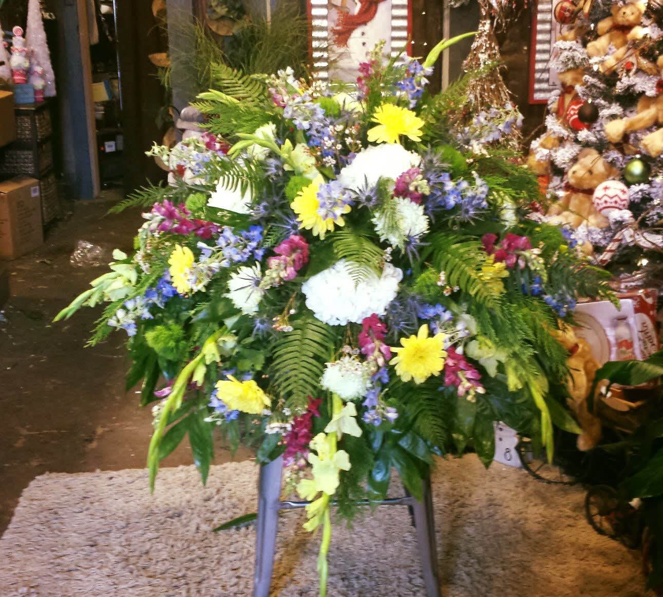 Large mixed floral spray with yellow, white, blue, and pink blooms