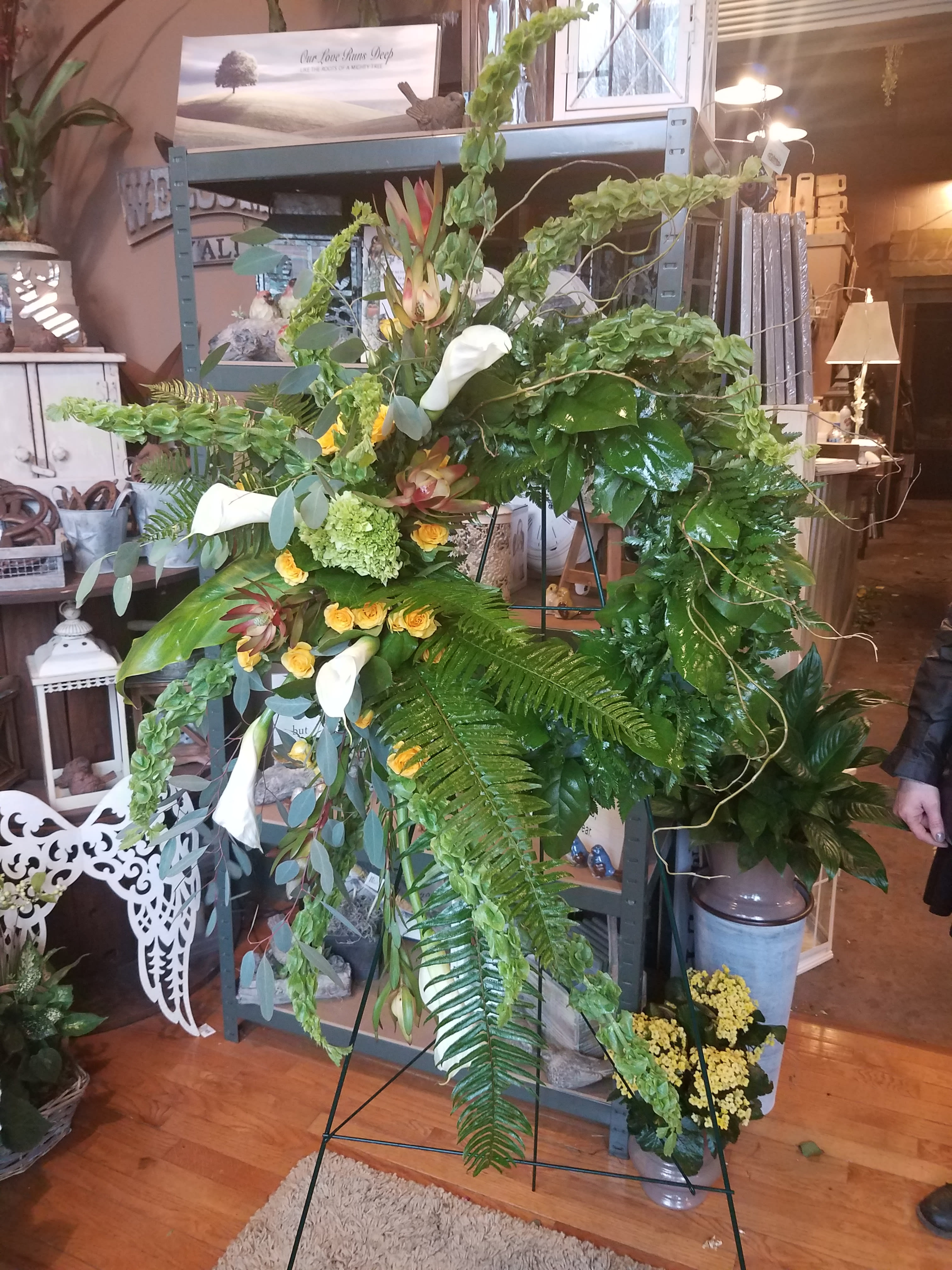 Large standing floral spray with white calla lilies and yellow roses