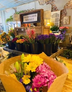 Bouquet of pink and yellow daisies with lilies in brown paper