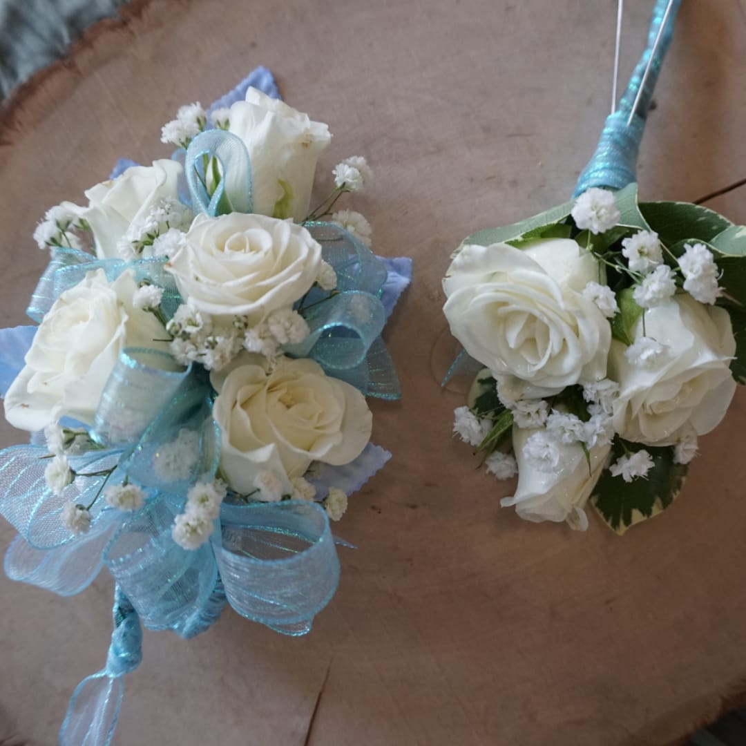 Two white rose wedding bouquets with blue ribbon accents