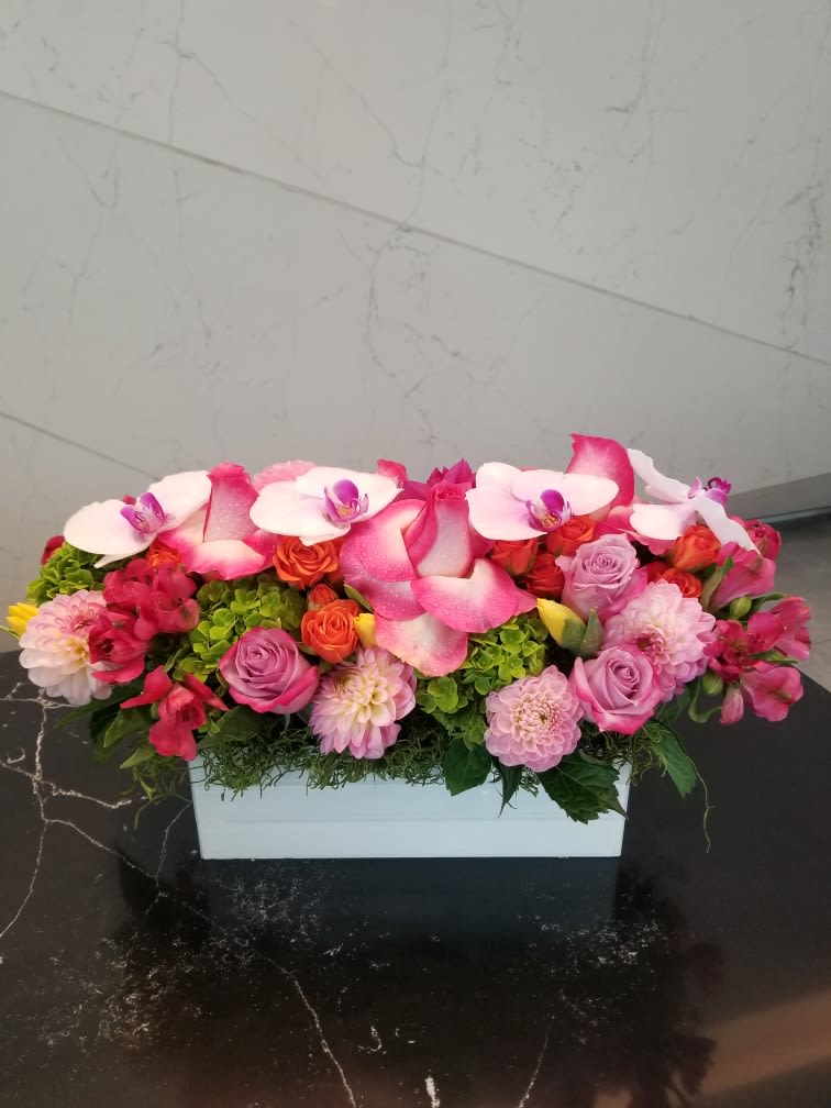Pink and white floral arrangement in a white rectangular box