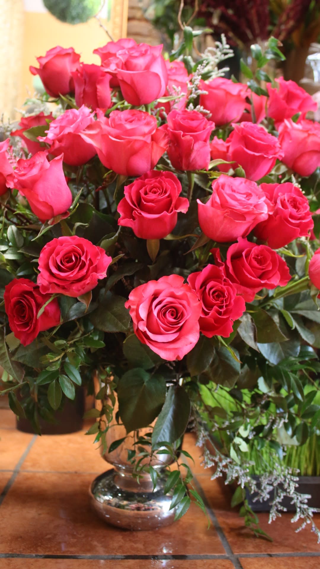 Pink roses arranged in a clear glass vase