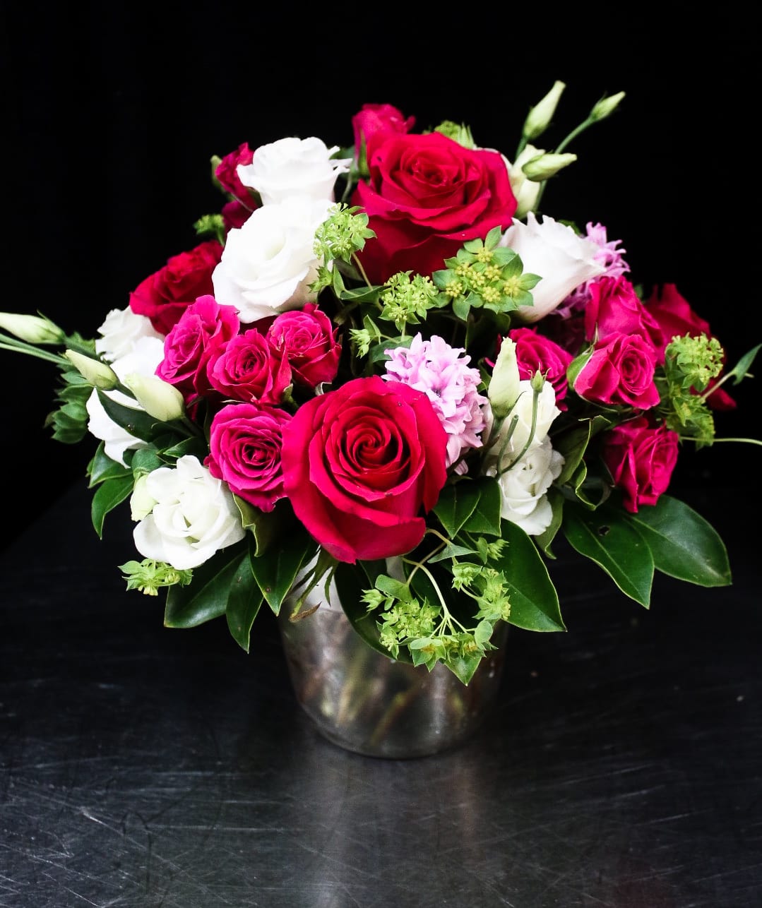 Bouquet of red and white roses in a metal vase