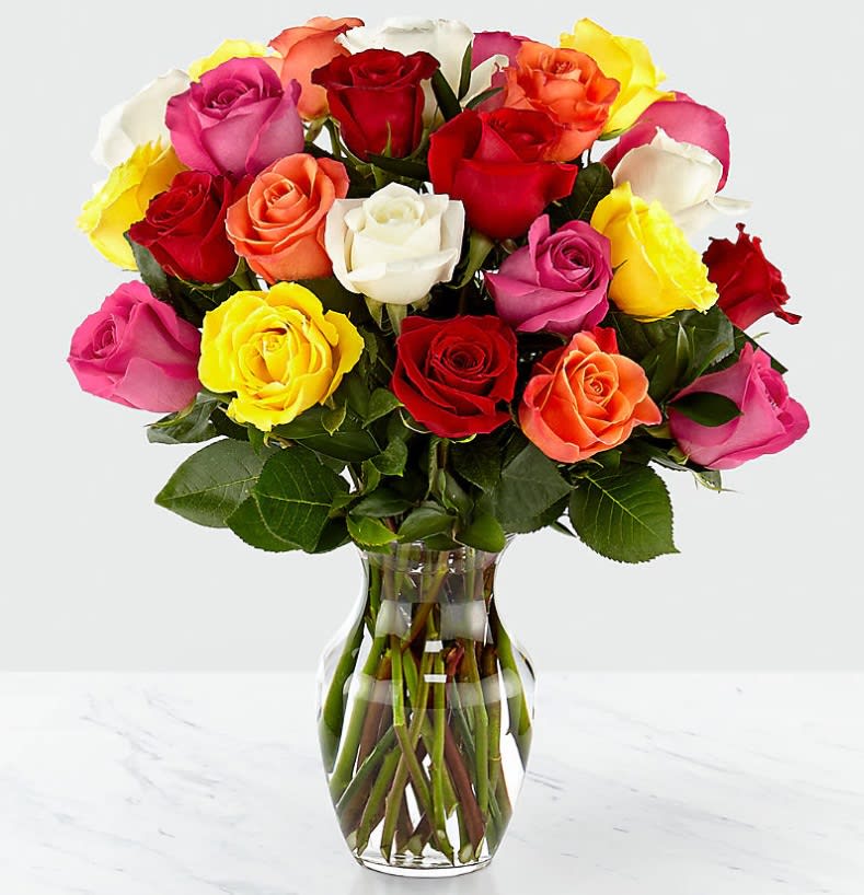 Mixed roses in a clear glass vase