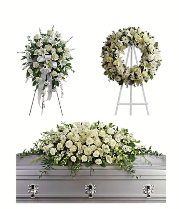 White floral funeral spray, wreath, and casket arrangement