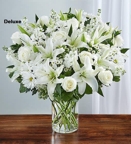 Sincerest Sorrow Bouquet  - Express your sincere condolences with our elegant all-white arrangement of roses, lilies, stock, daisy poms and monte casino. A peaceful tribute that offers treasured memories of loved ones.  Abundant bouquet of the freshest white roses, lilies, stock, daisy poms and monte casino, accented with variegated pittosporum, salal and myrtle Hand-designed by our expert florists in a classic glass cylinder vase; vase measures 8"H Can be sent to the home of friends, family members or business associates, or to the funeral service Large arrangement measures approximately 24"H x 22"L